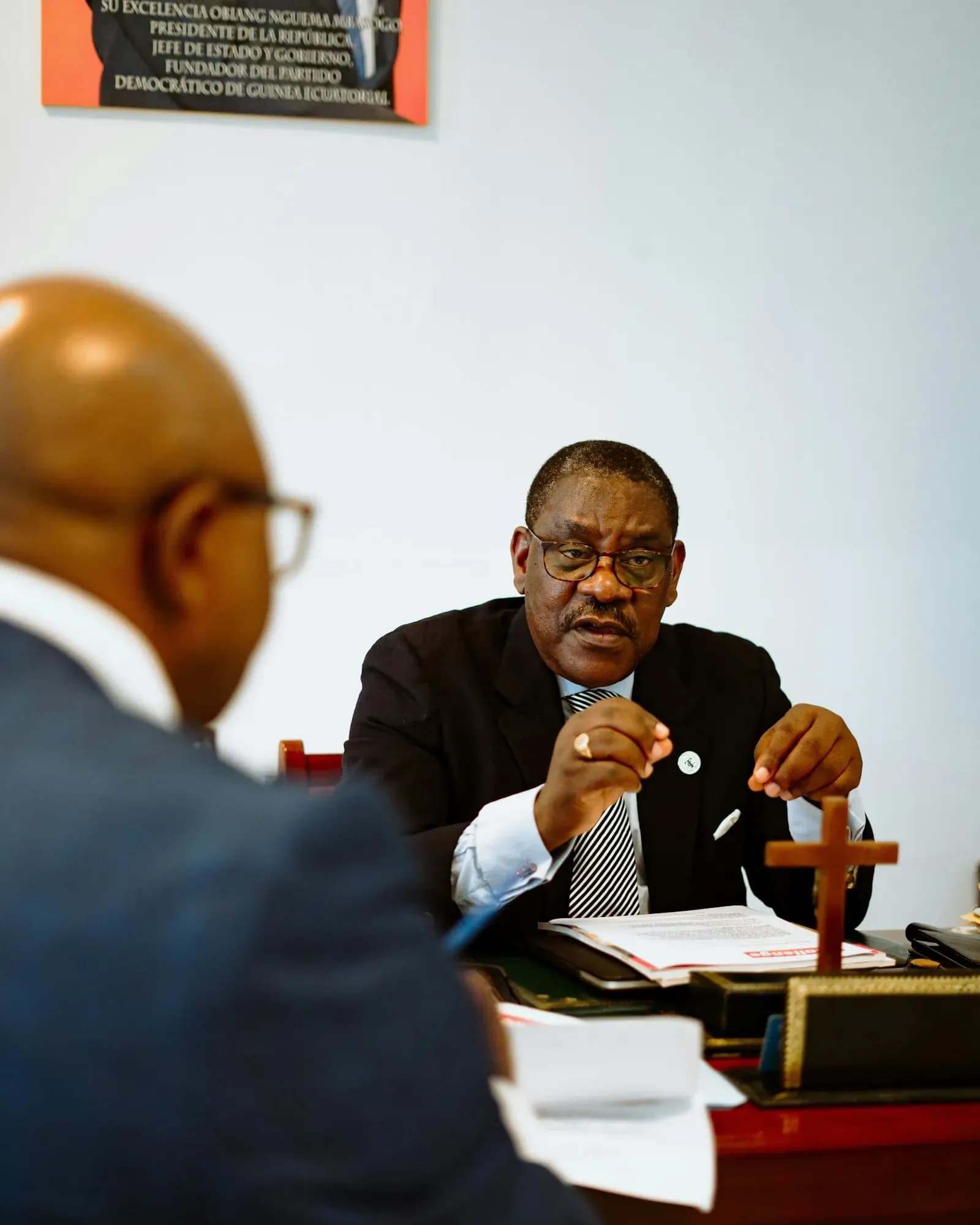 Two professionals discussing a case across an office desk