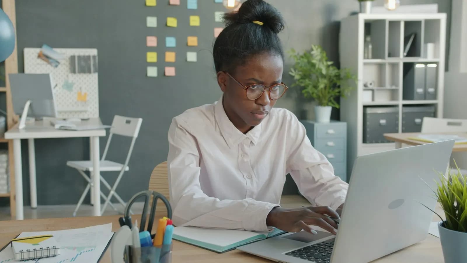 Woman working at her laptop in a bright office