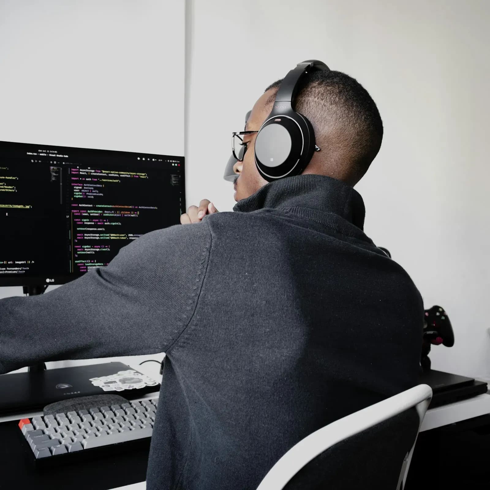 Developer with headphones working on code