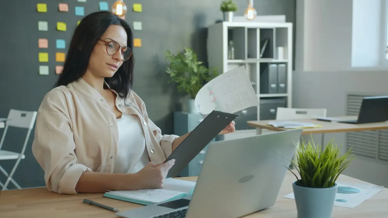 Woman reading a document at her laptop