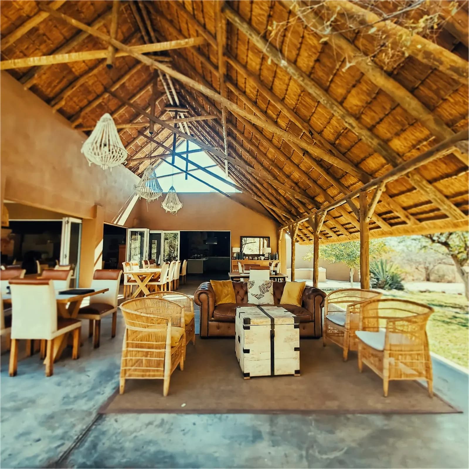 Open-sided safari lodge lounge with wooden furniture